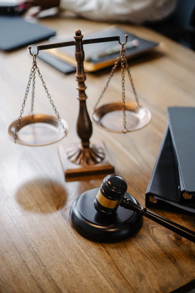 High angle lawyers desk with decorative judgement scales and gavel in modern law firm